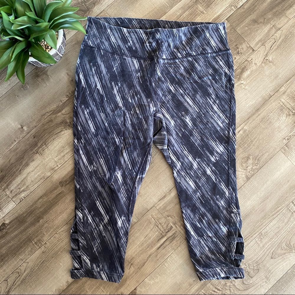Xersion multi-colored athletic Capri leggings with cut out detail on leg…